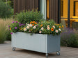 Mobil plantekasse i galvaniseret stål fra CUBY fyldt med farverige blomster