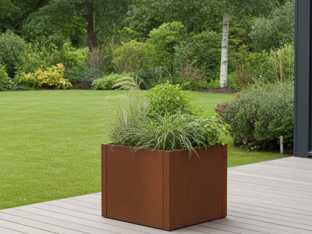 CUBY plantekasse i cortenstål med prydgræs og grønne planter