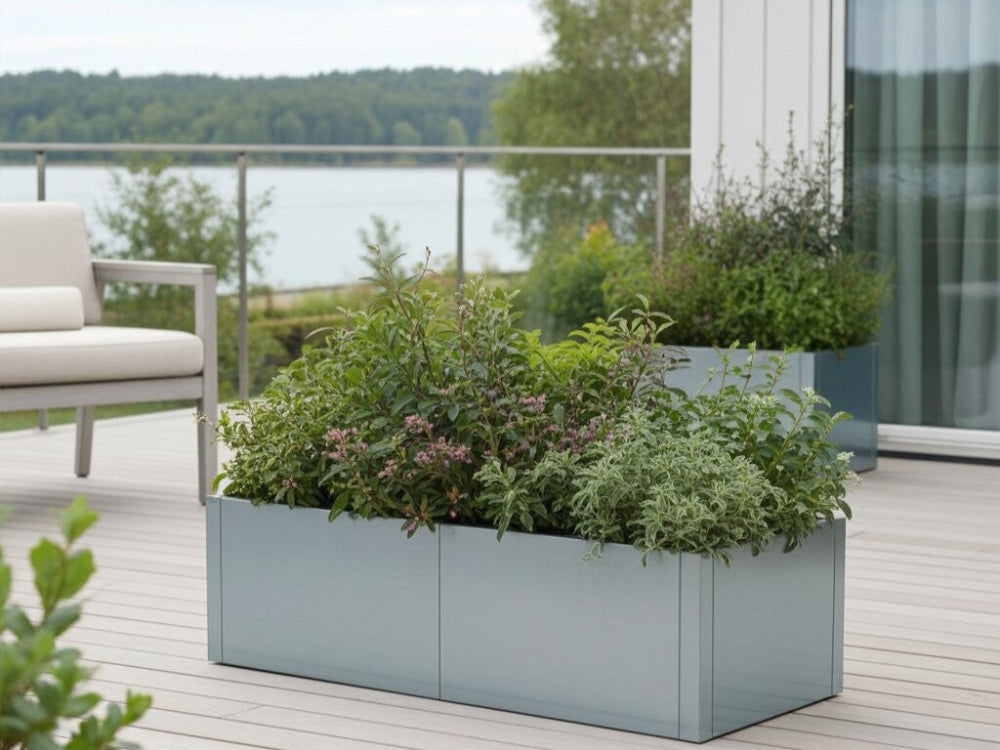 CUBY lav plantekasse i galvaniseret stål med grønne planter placeret på terrasse med udsigt